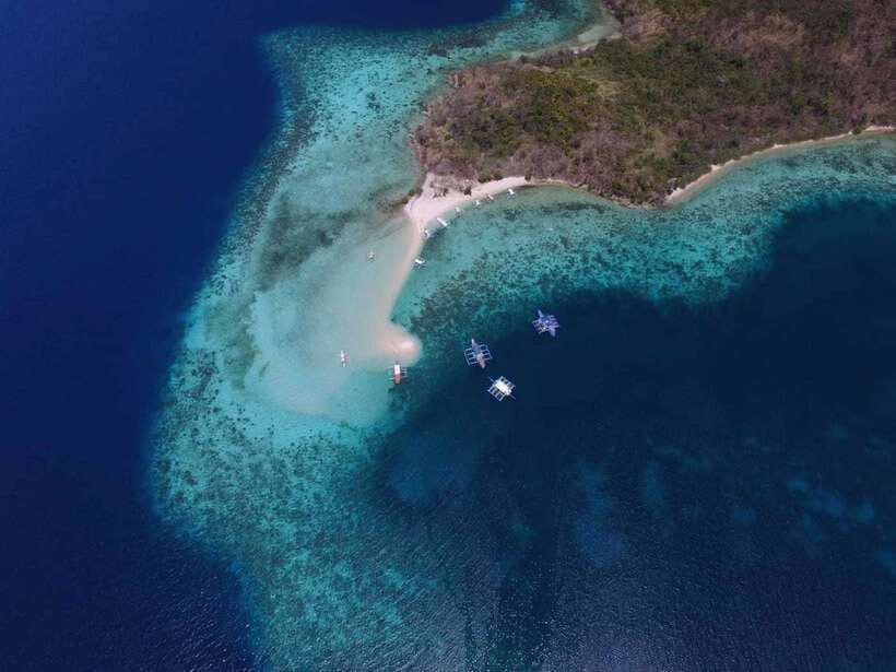 From Coron: Private Island-Hopping Cruise with Lunch - Banana Island, curved sand and reef close to shore