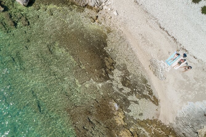 Luxury Speedboat Island Hopping with Swimming & Snorkeling - Firagola, sun, and a cold drink